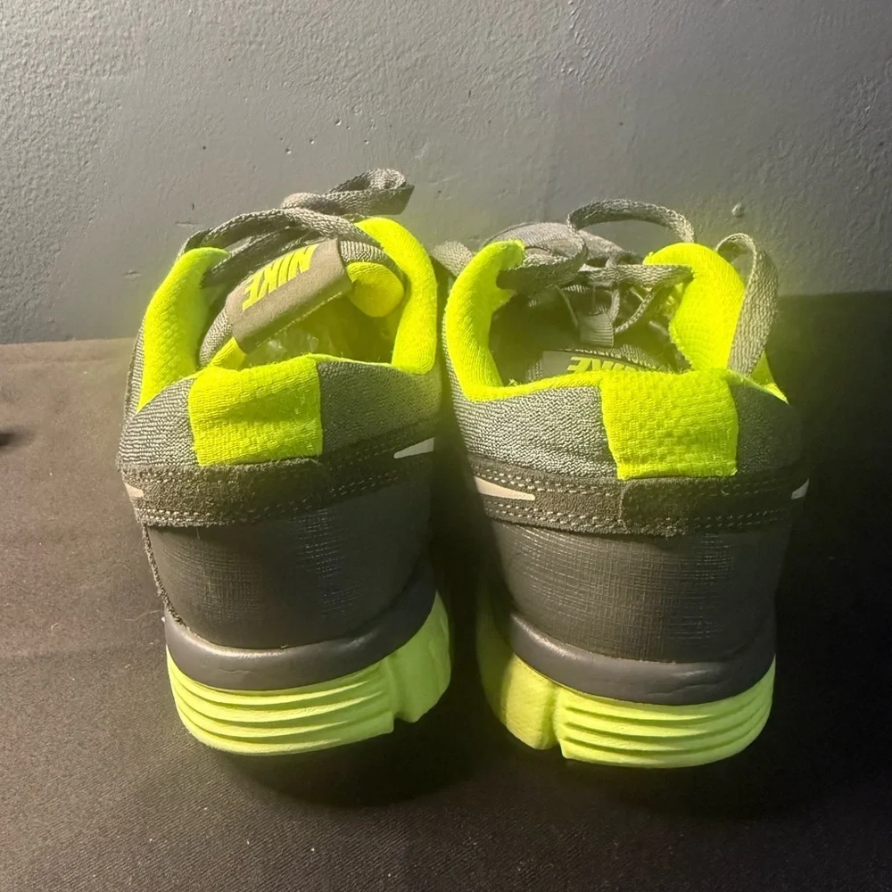Nike women’s Gray and Neon Green Dual Fusion Sneakers